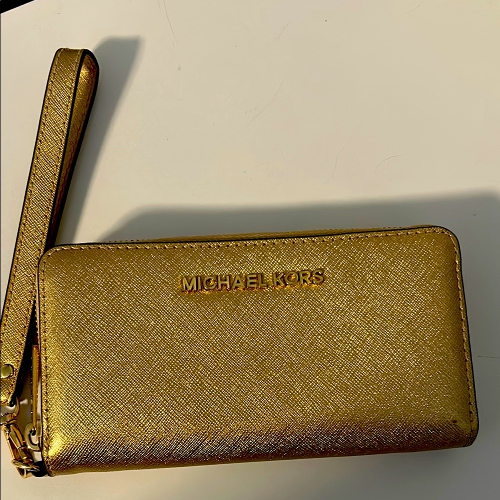 Michael Kors gold leather wristlet.